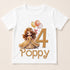 A white t-shirt with a cartoon image of a princess and balloons, along with the number "4" and the word "Poppy" printed on it.