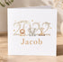A white greeting card with a design featuring a lion, elephant, and giraffe, along with the text "BORN IN 2023 Jacob".