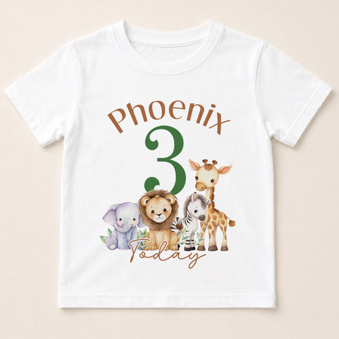 A white t-shirt with a graphic design featuring a group of cartoon animals, including a lion, giraffe, elephant, and zebra, along with the text "Phoenix 3 Today".