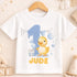 A white t-shirt with a cartoon image of a yellow duck and the number "1" printed on it, along with the text "JUDE".