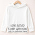 A white long-sleeved t-shirt with a hood is hanging on a wooden hanger against a light-colored background.