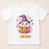A white t-shirt with a Halloween-themed graphic design featuring a ghost and a pumpkin.