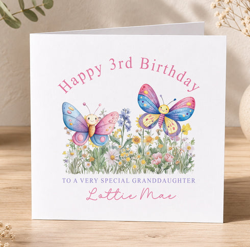 A birthday card with a floral design and two colorful butterflies.