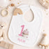 Personalised 1st birthday girl outfit with pink number 1, cute cupcake design, happy birthday text and custom name, shown on sleepsuit, t-shirt, vest, pyjamas and bib.