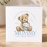 A greeting card with a teddy bear holding flowers and the text "Happy Mother's Day Mummy Love from Arthur" printed on it.