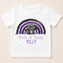 A white t-shirt with a graphic design featuring a cat and a rainbow. The cat is depicted as a bat-like creature, and the rainbow has purple and black colors. The text below the design says "Trick or Treat Riley".