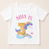 A white t-shirt with a graphic design featuring a unicorn and the number 3.