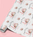 a roll of wrapping paper with a repeating pattern of birthday cakes and candles.
