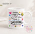 A white ceramic mug with a colorful design featuring text and illustrations related to Father's Day.