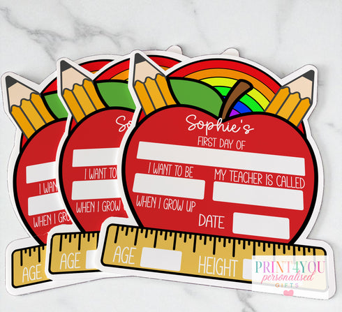 The image is a collage of three stickers, each depicting a red apple with a pencil and a rainbow, along with text that reads "Sophie's First Day of School".