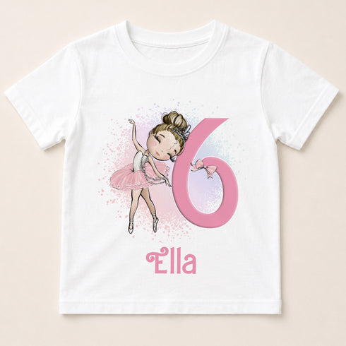 A white t-shirt with a cartoon image of a young girl in a pink tutu and ballet slippers, along with the number 6 and the name "ella" printed on it.