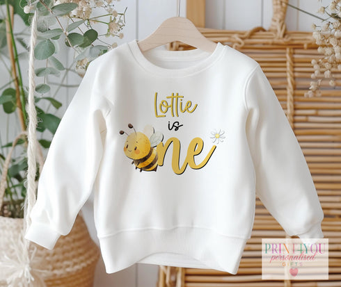 Personalised "Bee is One" 1st Birthday Jumper โ Custom Name โ White Baby & Toddler Sweatshirt โ Soft Cotton Blend โ DTG Print