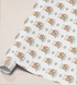 Printed christmas wrapping paper shown as wrapping paper