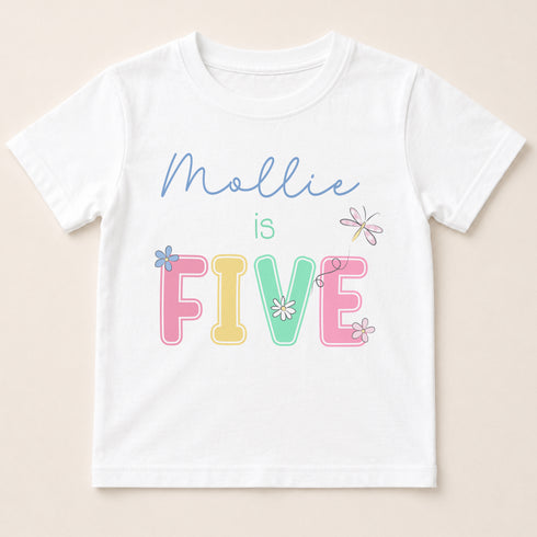 A white t-shirt with the text "Mollie is FIVE" printed on it.