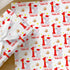 Personalised Baby's First Christmas Wrapping Paper featuring elephant in Santa hat, custom name and festive Christmas design.