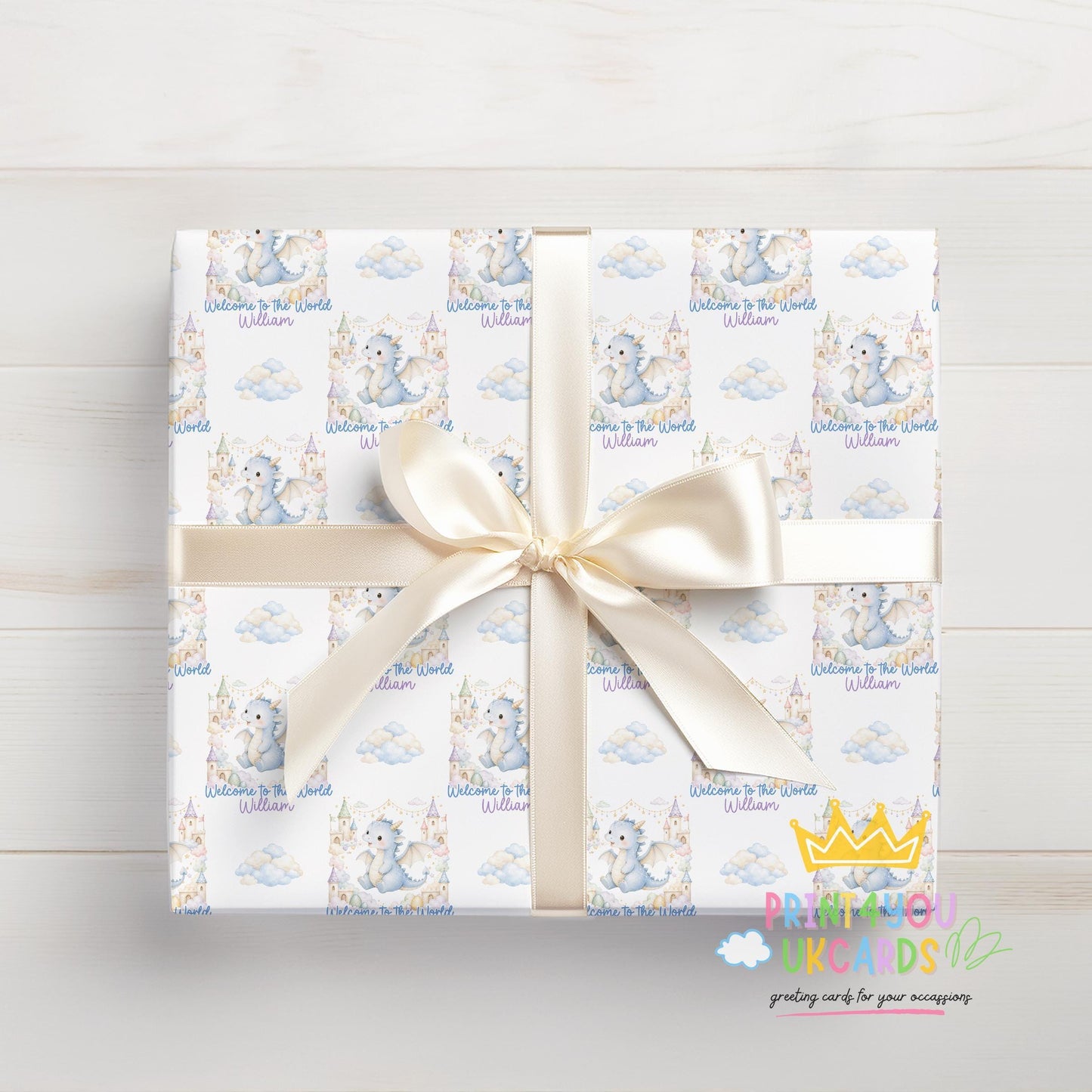 Roll of the personalised blue dragon baby wrapping paper displayed on a flat surface