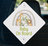 A diamond-shaped sign with a rainbow and various animals, including a giraffe, elephant, and lion, along with the text "Baby On Board".