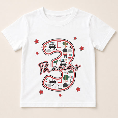A white t-shirt with a graphic design featuring the number 3 and various icons, including a car, a train, and a building.