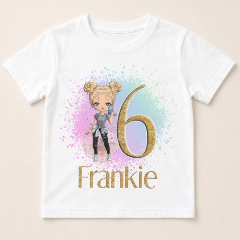 A white t-shirt with a graphic design featuring a cartoon girl and the number 6.