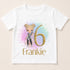 A white t-shirt with a graphic design featuring a cartoon girl and the number 6.