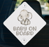 a baby elephant on a sign that says "Baby on Board".