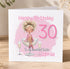 A birthday card for Sophie, celebrating her 30th birthday. The card features a cartoon illustration of a woman sitting in a glass, surrounded by champagne glasses and confetti. The text on the card reads "Happy Birthday Sophie" and "To my beautiful Sister Sophie".