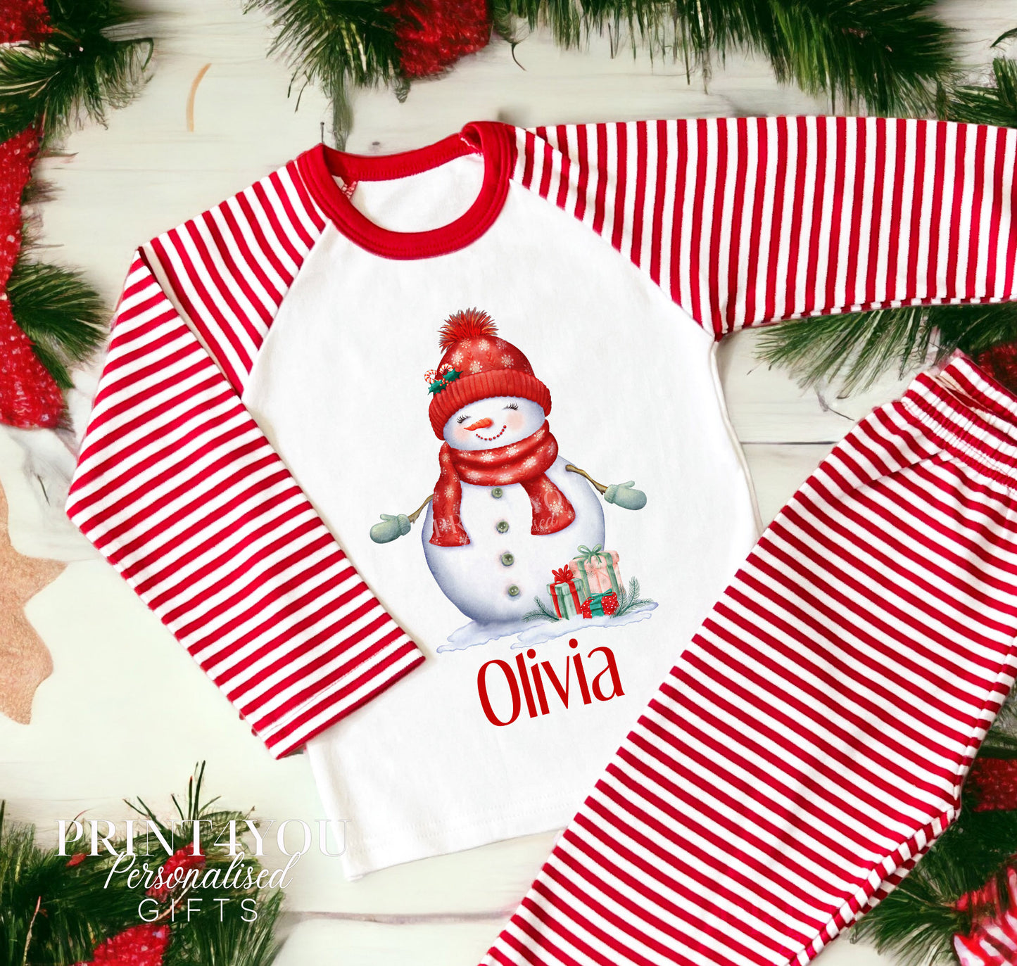 Personalised red and white striped Christmas Eve pyjamas for kids with Snowlady design and custom name printed on the front