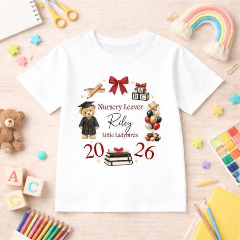 Personalised nursery leaver t-shirt featuring graduation teddy bear, books, balloons and school theme design with custom name, nursery name and year in red colours