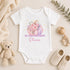 Personalised baby’s first Halloween white vest featuring a pastel pink and purple floral pumpkin, golden stars and baby’s name.