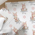 Personalised Christmas wrapping paper featuring a cute bunny rabbit in a pink knitted hat and scarf, custom name Christmas gift wrap with festive snowflakes.