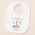 A white baby bib with a playful design featuring a dolphin, fish, and other marine life, along with the text "When I wake up I will be 1 Summer".