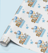 The image is a roll of wrapping paper with a repeating pattern of cartoon animal illustrations, including elephants, lions, and other animals, along with blue balloons and stars.