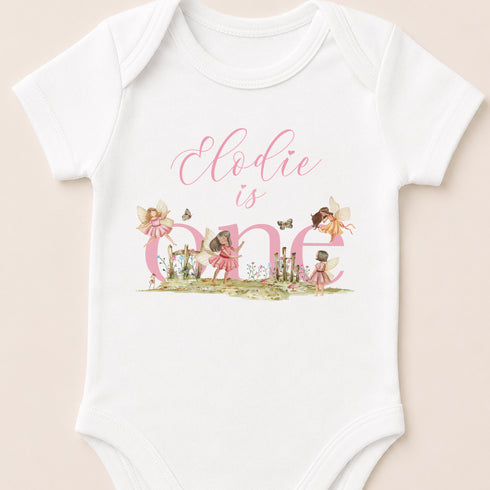 A white onesie with a personalized text and illustrations on it.