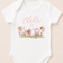 A white onesie with a personalized text and illustrations on it.