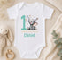 Personalised first birthday vest with elephant design and custom name, styled with soft toys and greenery