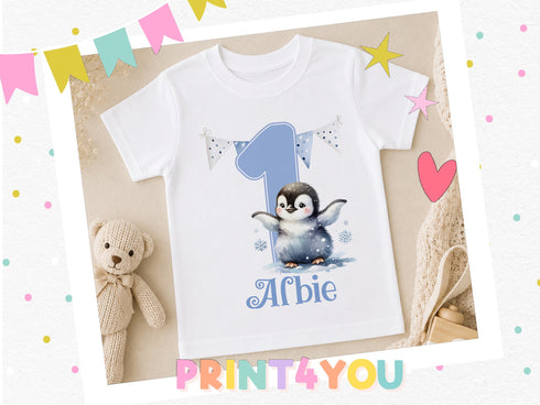 A white t-shirt with a penguin graphic and the number 1, along with the text "Afbie" printed on it, is displayed in the image.