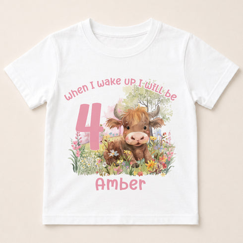 A white t-shirt with a printed design featuring a cow surrounded by flowers and a number 4.