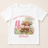 A white t-shirt with a printed design featuring a cow surrounded by flowers and a number 4.