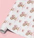 Personalised teddy bear birthday wrapping paper featuring a cute teddy holding a pink present, custom name and birthday message for girls.