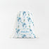 A white drawstring bag with a pattern of blue dolphins and other marine life printed on it. The bag has a white drawstring and a name tag that says "AVERY".