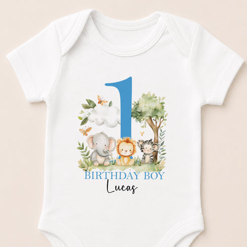 A white baby onesie with a blue number 1 and a graphic of an elephant, lion, and tiger.