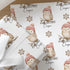 Personalised Christmas wrapping paper featuring a cute owl wearing a pink knitted winter hat, custom name Christmas gift wrap with festive snowflakes.