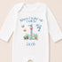 A white onesie with a personalized message and illustrations of marine animals, including a dolphin, starfish, and fish, printed on it.