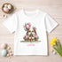 A white t-shirt with a bunny graphic and the text "Happy Easter Lottie" printed on it, surrounded by Easter decorations such as eggs, flowers, and a basket of eggs.