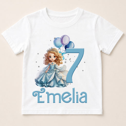 A white t-shirt with a cartoon image of a girl and balloons, along with the text "Emilia" below the image.