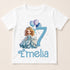 A white t-shirt with a cartoon image of a girl and balloons, along with the text "Emilia" below the image.