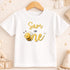 A white t-shirt with a yellow bee graphic and the text "Sam is one" printed on it.
