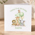 A personalized first birthday card featuring a cartoon illustration of a lion, giraffe, and elephant, along with the number 1 and the text "Happy First Birthday to a lovely Grandson Ralphie".
