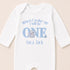 A white onesie with a blue elephant and text that says "When I wake up I will be ONE Luca Jack" printed on it.