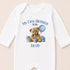 A white onesie with a teddy bear and a blue balloon, along with the text "My First Birthday Jacob" printed on it.